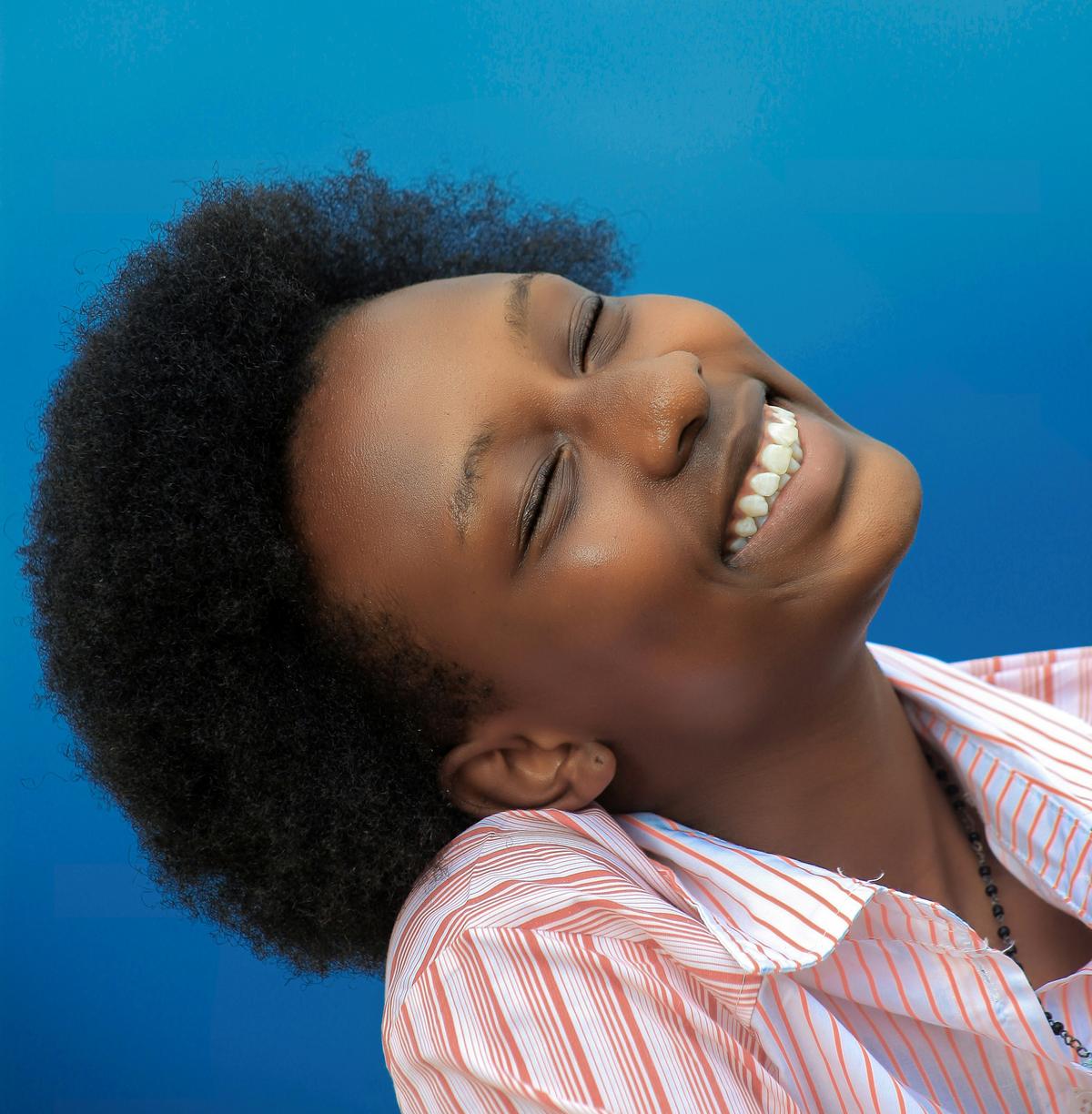 Patient showing their new smile after same-day dental implant procedure
